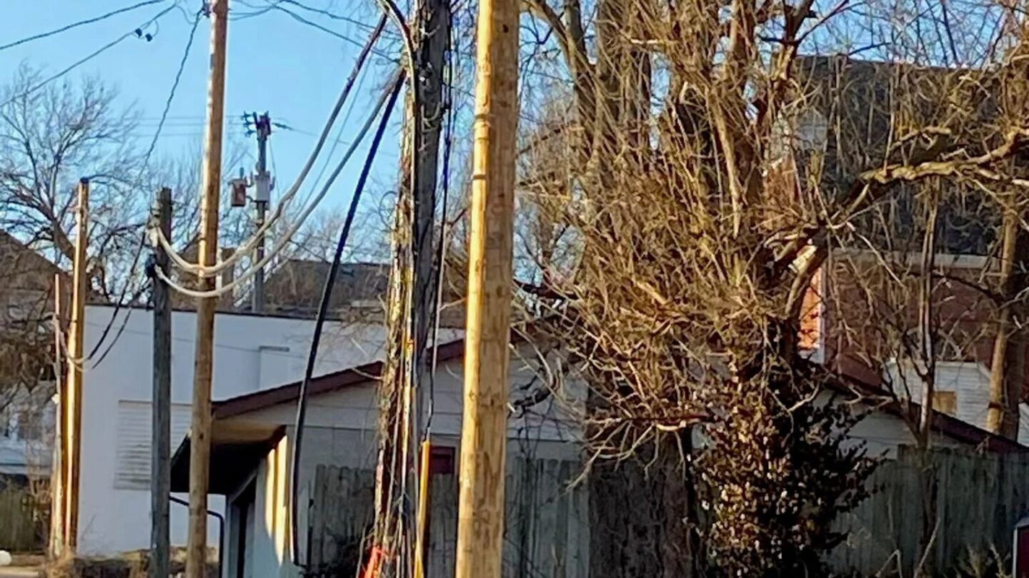 Optimum’s fiber optic cables hang down a wooden pole after they’ve been cut in St. Joseph.