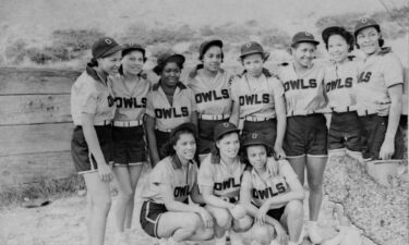 Eleven members of the Owls pose for a team photo. A handwritten slip with the photograph identifies the players as
