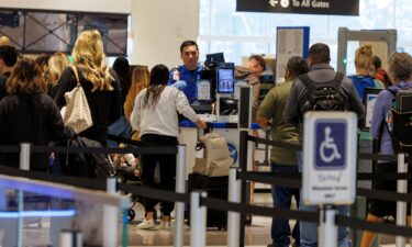 A TSA agent checks travelers at San Diego International Airport during the 2025 government shutdown in San Diego