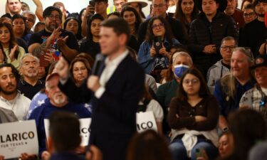 Campaign pins are displayed at a rally for James Talarico in El Paso