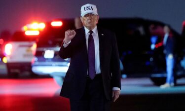 US President Donald Trump pumps his fist after disembarking Air Force One at Palm Beach International Airport in West Palm Beach