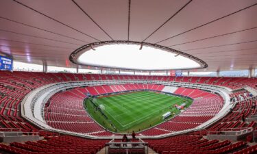 Firefighters extinguish a burning bus set on fire by organized crime groups in response to an operation in Jalisco to arrest a high-priority security target