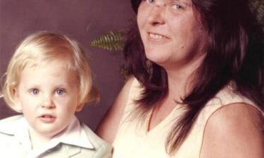 Jimmy Hendrickson is seen as a young child next to his mother in a family photograph.