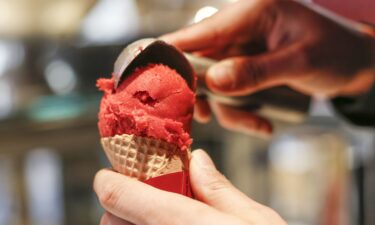 An employee fills an ice cream cone at the Häagen-Dazs shop opening in Sylt