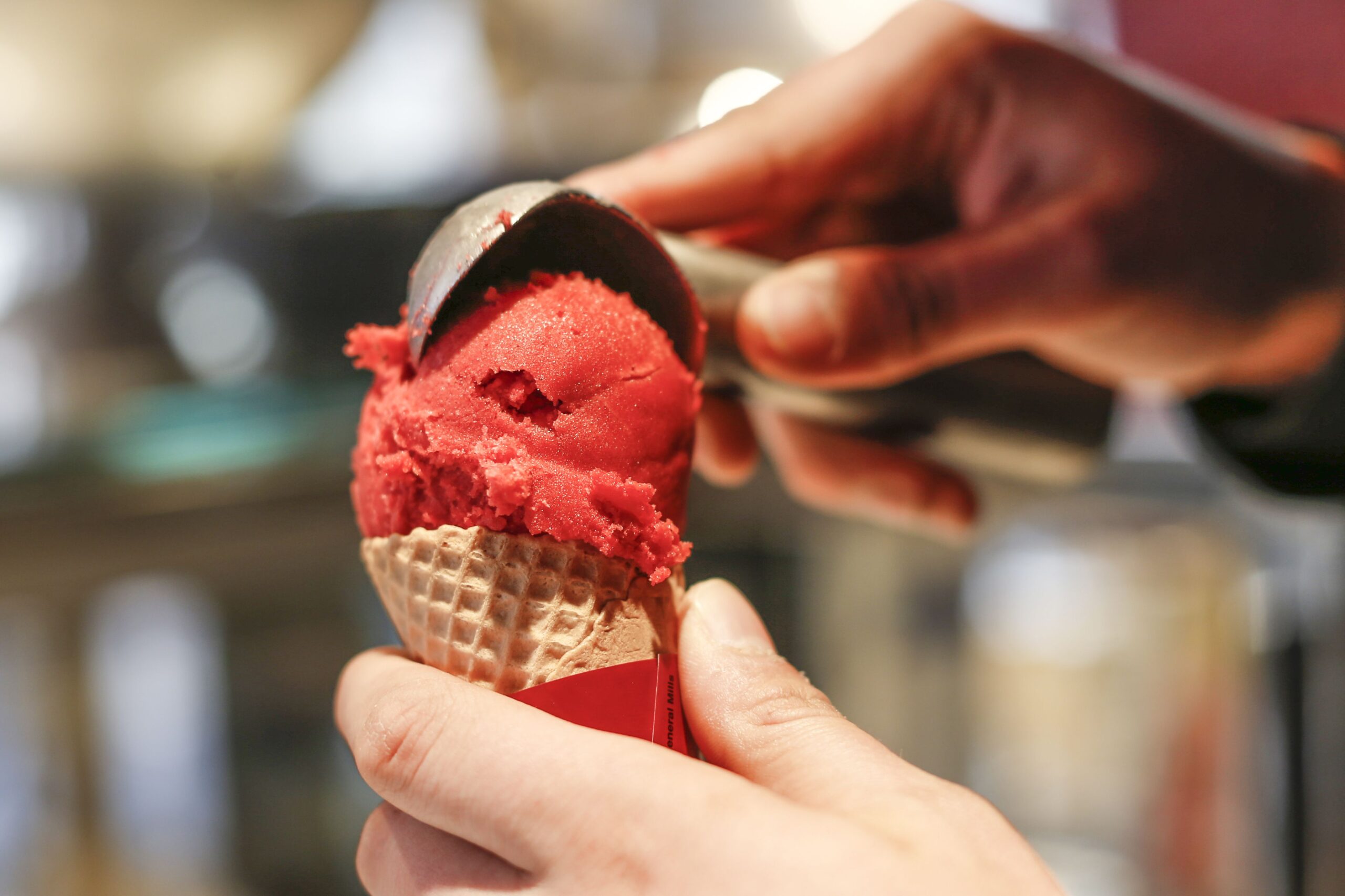 <i>Franziska Krug/Getty Images via CNN Newsource</i><br/>An employee fills an ice cream cone at the Häagen-Dazs shop opening in Sylt
