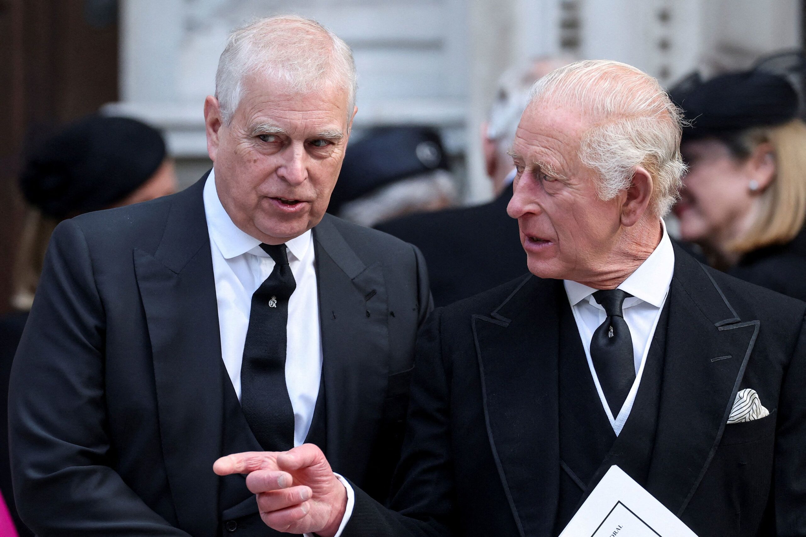 <i>Toby Melville/Reuters via CNN Newsource</i><br/>Andrew Mountbatten-Windsor speaks with King Charles as they leave Westminster Cathedral in London in September.
