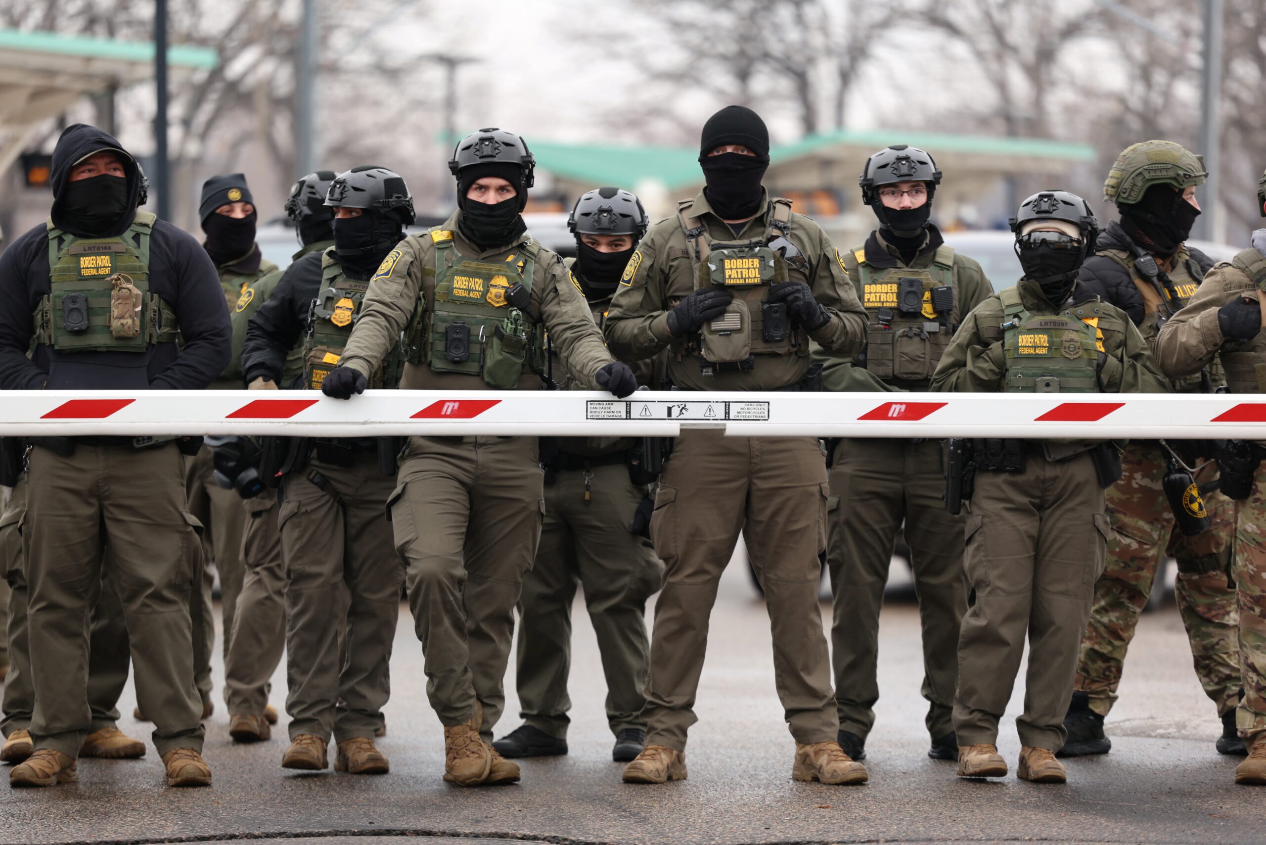 <i>Charly Triballeau/AFP/Getty Images via CNN Newsource</i><br/>US Border Patrol agents stand guard at the Bishop Henry Whipple Federal Building in Minneapolis