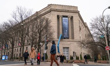 A banner showing President Donald Trump is hung from the Department of Justice