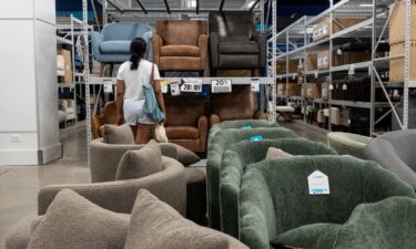 A shopper looks at chairs for sale at a store in Queens
