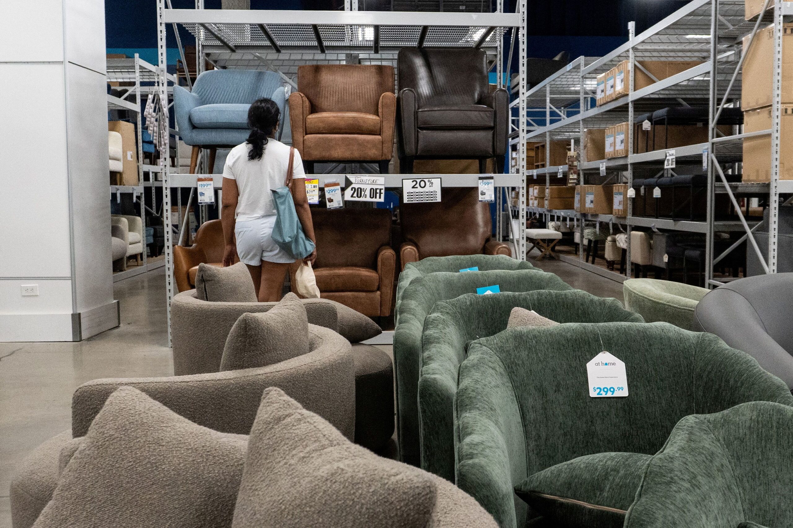 <i>Kylie Cooper/Reuters/FILE via CNN Newsource</i><br/>A shopper looks at chairs for sale at a store in Queens
