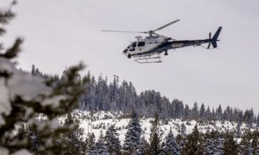 A California Highway Patrol helicopter lifts off from a field after a mission with a search and rescue crew in Truckee