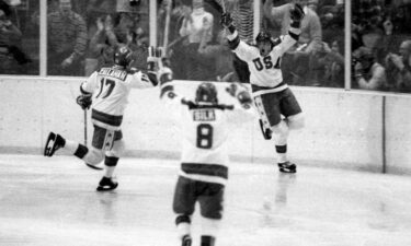 Members of the US Olympic ice hockey team get advice from coach Herb Brooks