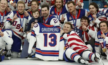 Macklin Celebrini of Canada shoots at goal as Connor Hellebuyck of United States makes a save.