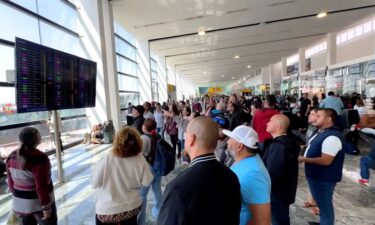 Travelers look for information at Guadalajara International Airport.