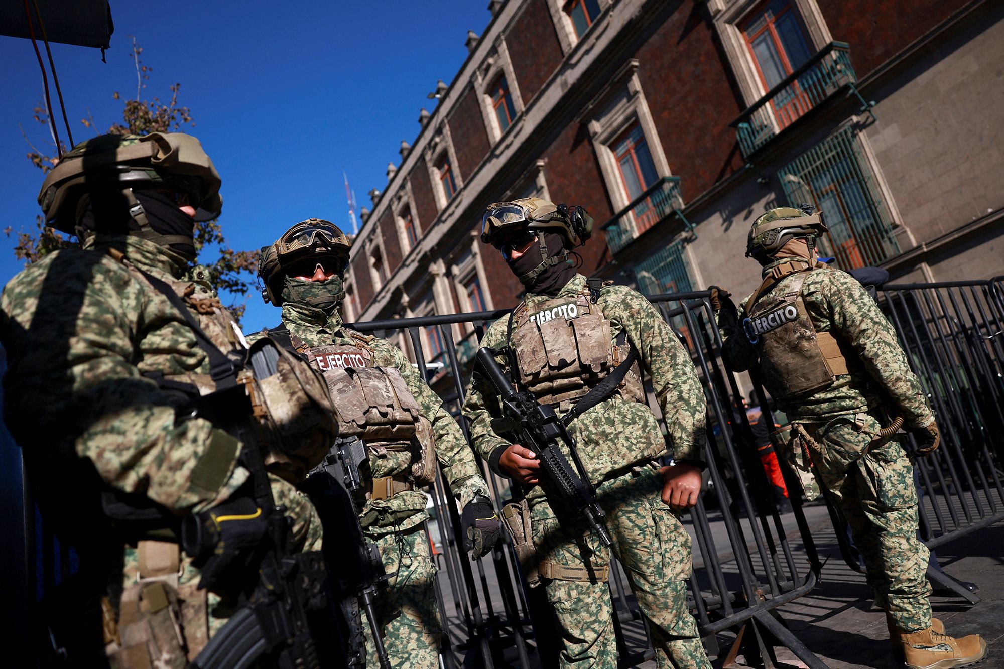 <i>Raquel Cunha/Reuters via CNN Newsource</i><br/>Military personnel patrol the Palacio Nacional in Mexico City following the killing of drug lord 