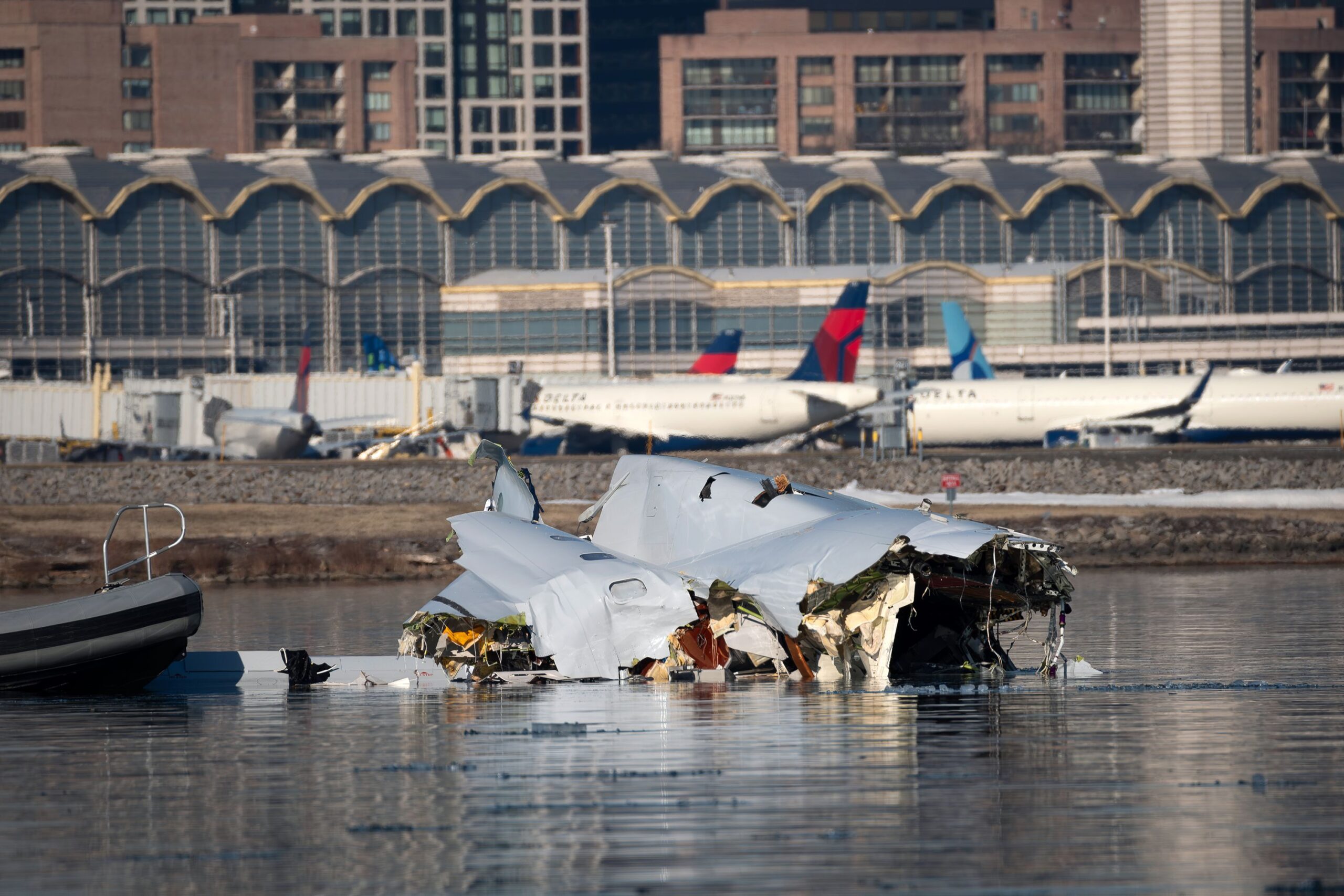 <i>Carlos Barria/Reuters via CNN Newsource</i><br/>A person looks on from the bank of the Potomac River near where a US Army helicopter collided with an American Airlines regional jet landing at Ronald Reagan Washington National Airport on January 29
