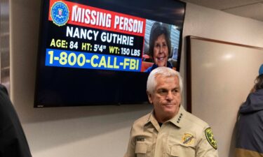 Pima County Sheriff Chris Nanos exits the press room past a missing persons poster after giving an update on the investigation into the disappearance of Nancy Guthrie