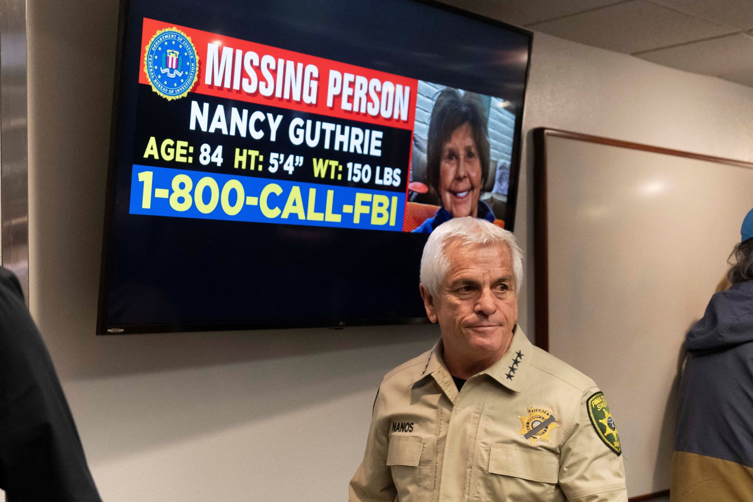 <i>Rebecca Noble/Reuters via CNN Newsource</i><br/>Pima County Sheriff Chris Nanos exits the press room past a missing persons poster after giving an update on the investigation into the disappearance of Nancy Guthrie