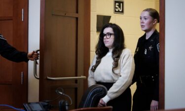 Juliana Peres Magalhães is escorted into the courtroom before testifying at Brendan Banfield's double murder trial on January 14.