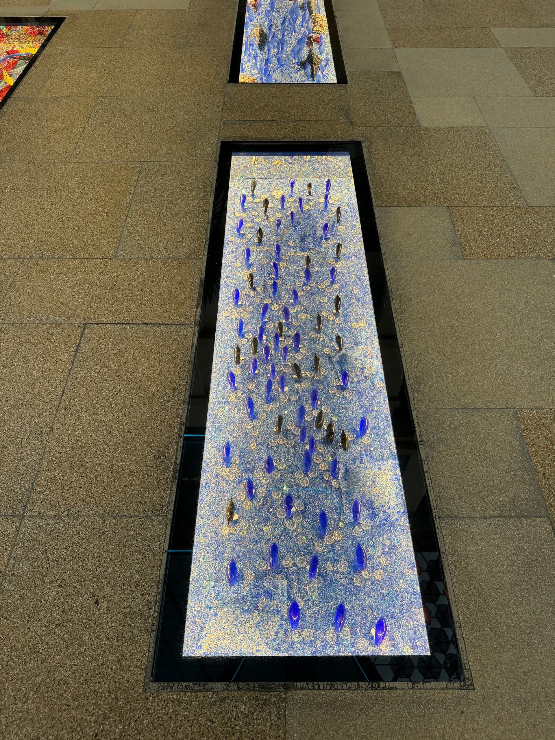 <i>Ulrike Lemmin-Woolfrey via CNN Newsource</i><br/>The waterfront promenade on Gewan is framed by glass trees inspired by artist Dale Chihuly.