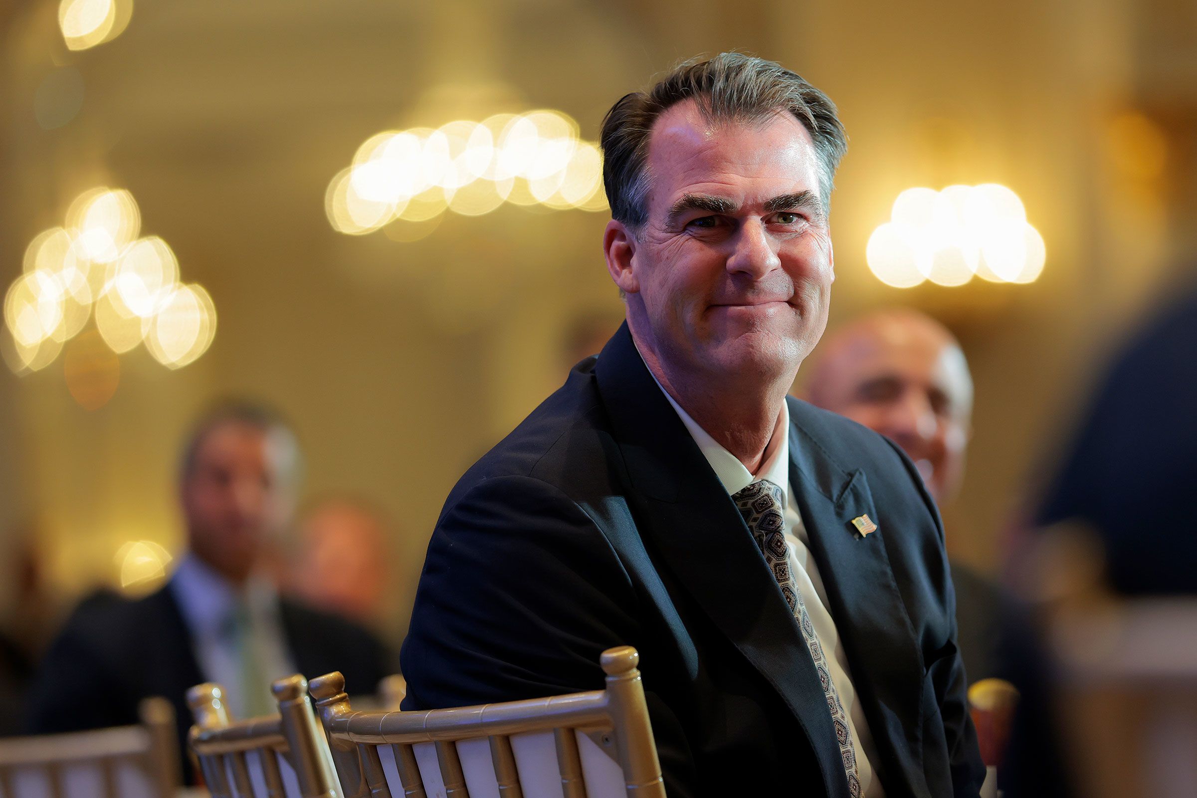 <i>Heather Diehl/Getty Images via CNN Newsource</i><br/>Oklahoma Gov. Kevin Stitt is introduced by David Rubenstein