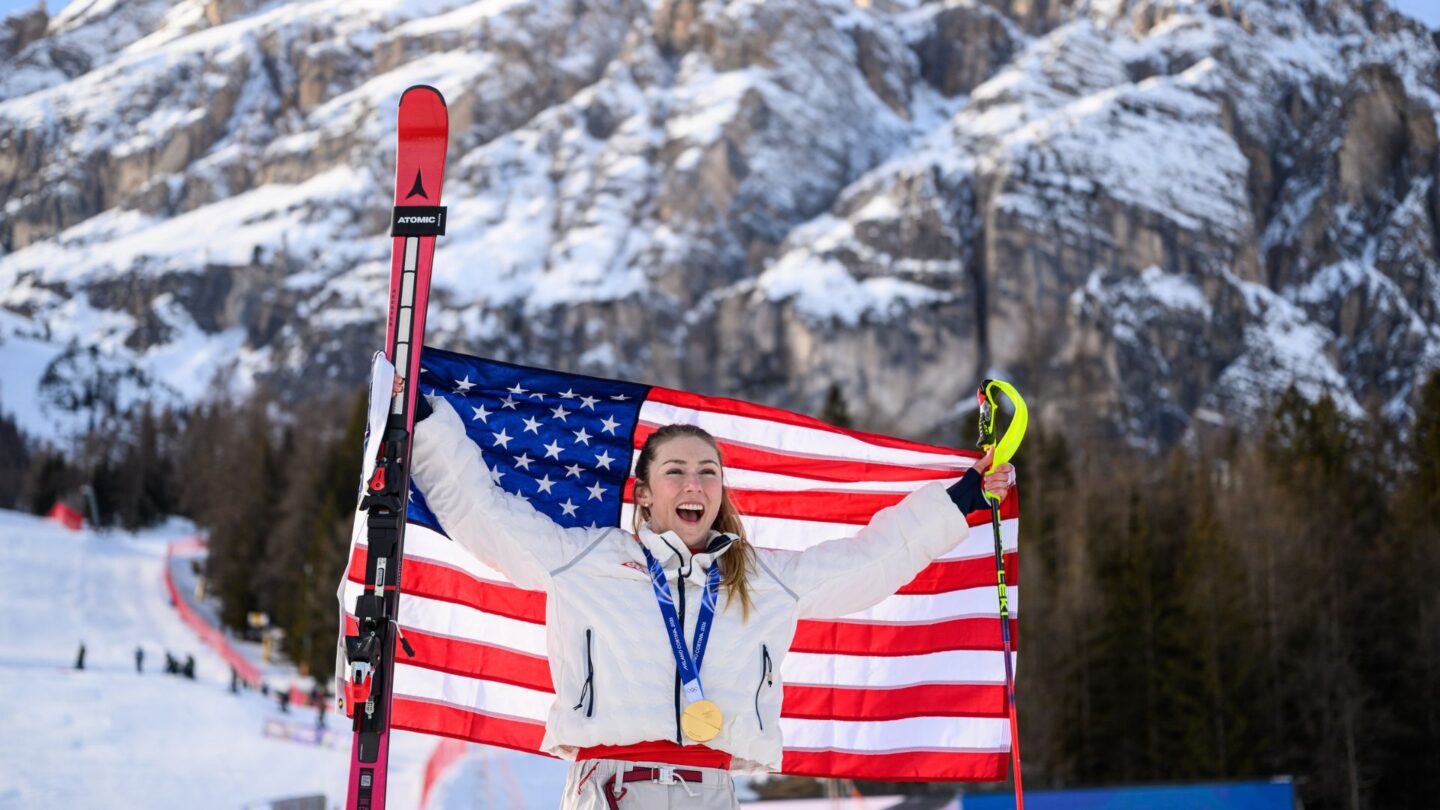 <i>NBC Olympics</i><br/>Mikaela Shiffrin holds up the flag of the United States in Livigno.