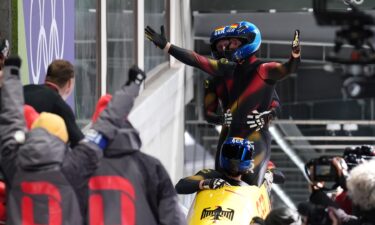 Johannes Lochner celebrates in sled after final run