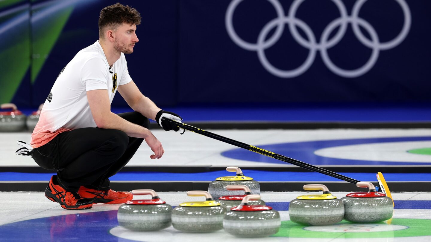 German curler squats on ice