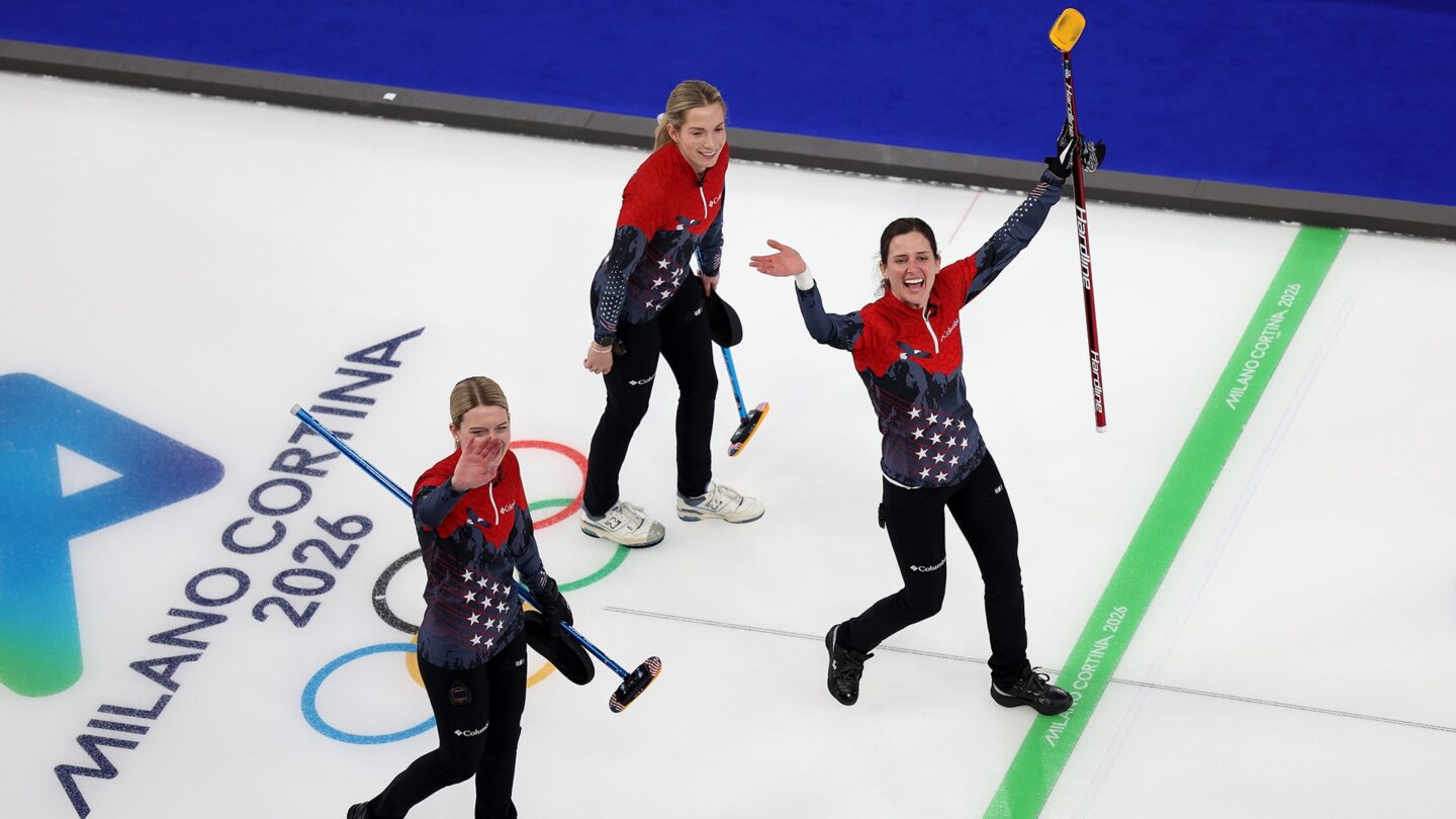 The U.S. women's curling team waves to fans after the win