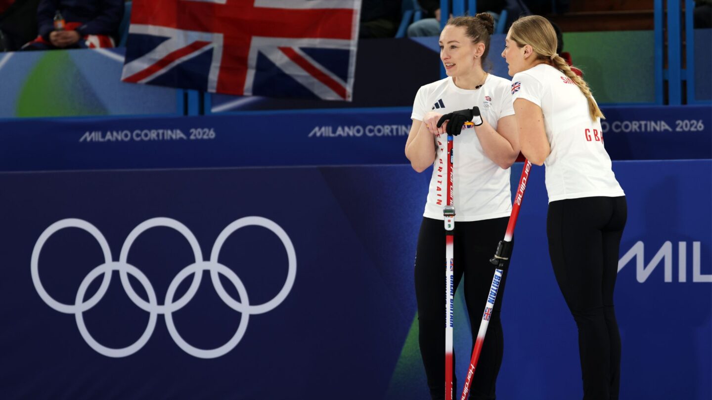 Great Britain curlers talk over their brooms