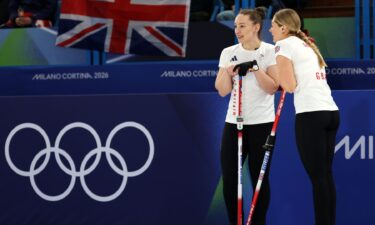 Great Britain curlers talk over their brooms