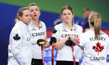 Canada curlers hold their brooms