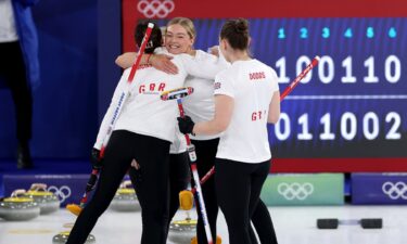 Great Britain curlers hug after the win