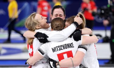 Switzerland curlers hug to celebrate win