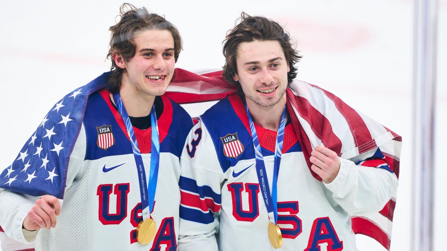 <i>NBC Olympics</i><br/>Jack Hughes and Quinn Hughes celebrate with the American flag and Olympic Gold medals