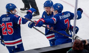 Brady Tkachuk and Charlie McAvoy celebrate a goal.