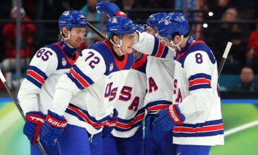 U.S. men's hockey player Tage Thompson celebrates with his teammates after scoring against Germany.