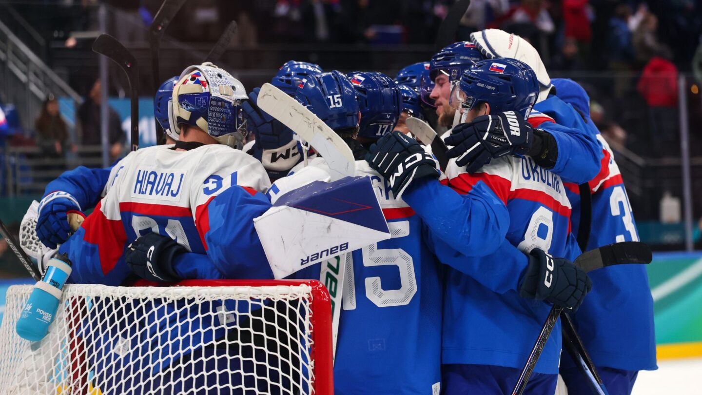 <i>NBC Olympics</i><br/>Slovakia's men's hockey team huddles near the goal on the ice with their arms on each other's shoulders after defeating Germany in the Olympic quarterfinal round.