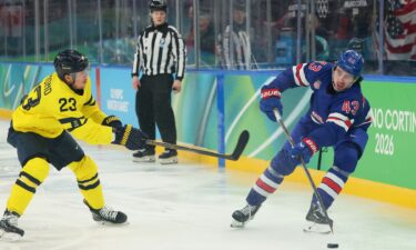 Team USA's Quinn Hughes carries the puck during overtime of the Olympic hockey semifinals.