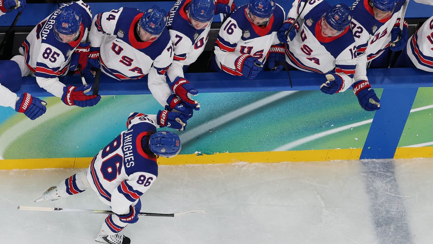 <i>NBC Olympics</i><br/>U.S. men's hockey player Jack Hughes high fives the bench after scoring over Slovakia in the Olympic semifinal round.