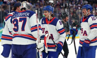 The U.S. men's hockey team celebrates on the ice after defeating Slovakia in the Olympic semifinal round.