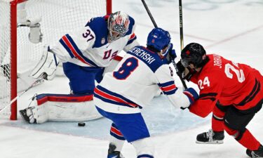 Connor Hellebuyck saves a goal against Canada