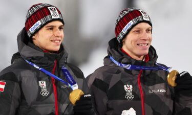 Stephan Embacher and Jan Hoerl pose with their medals