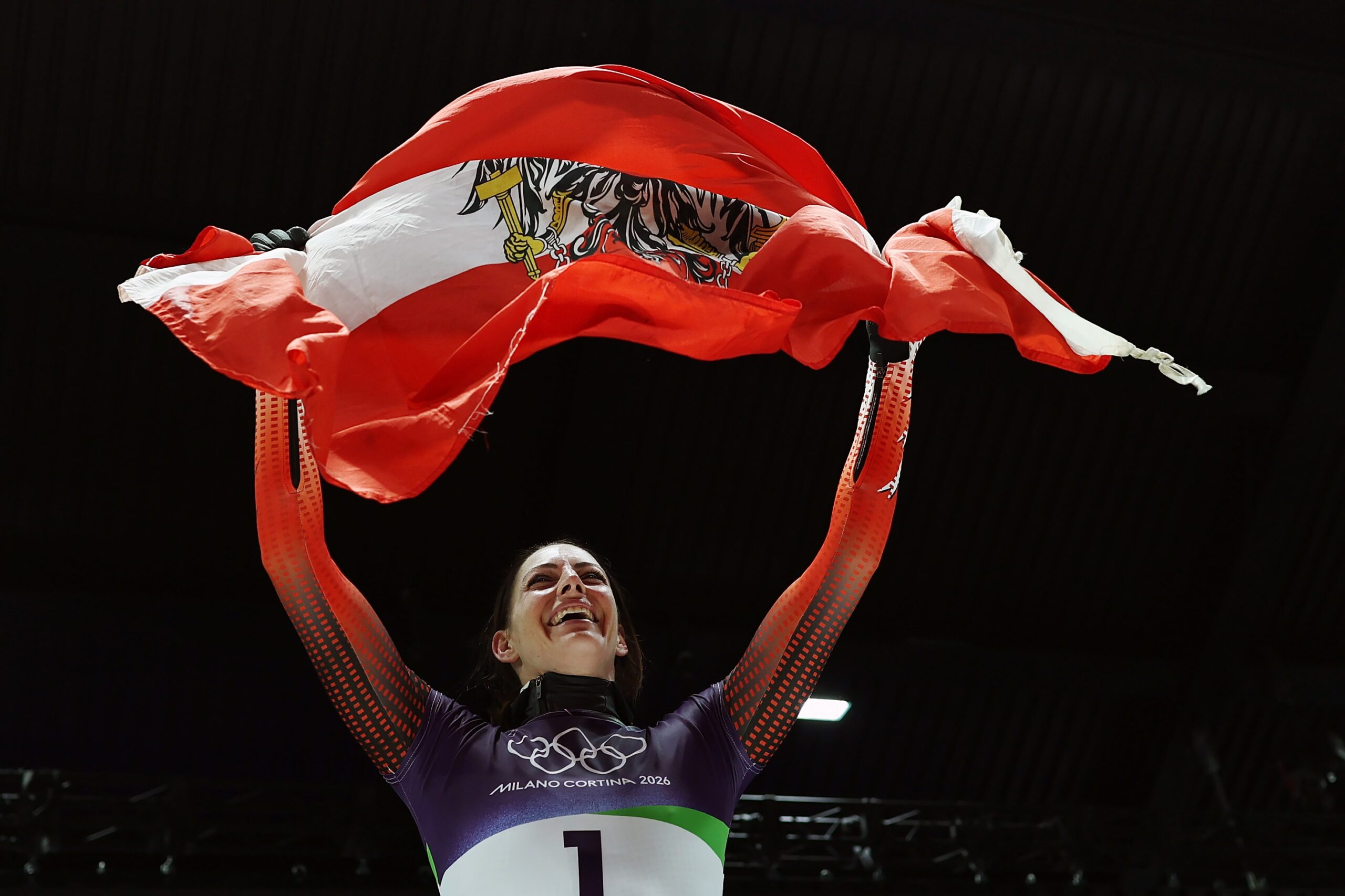 Janine Flock holds Austrian flag above her head