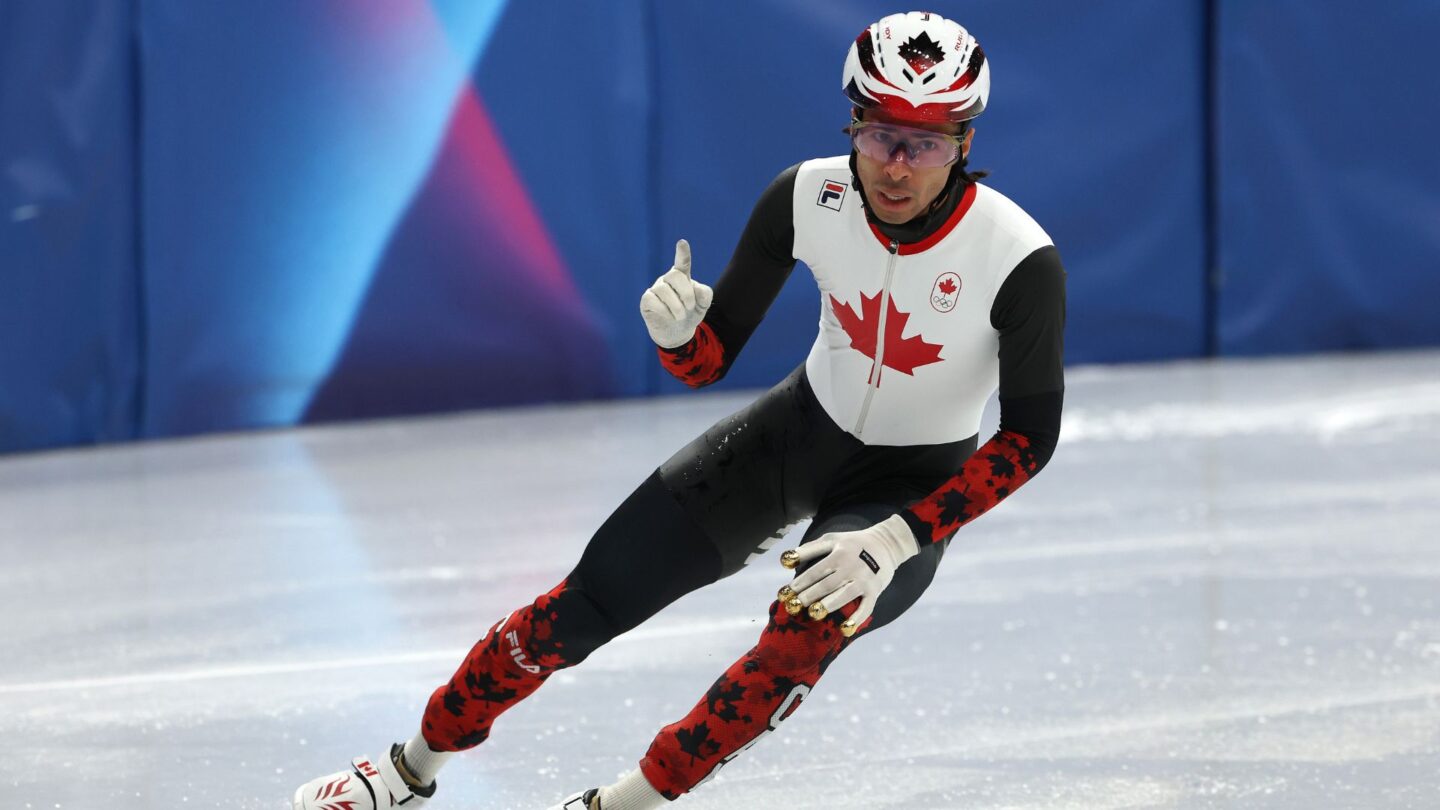 Canada's William Dandjinou celebrates after crossing the finish line in the men's 5000m relay semis