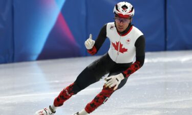 Canada's William Dandjinou celebrates after crossing the finish line in the men's 5000m relay semis