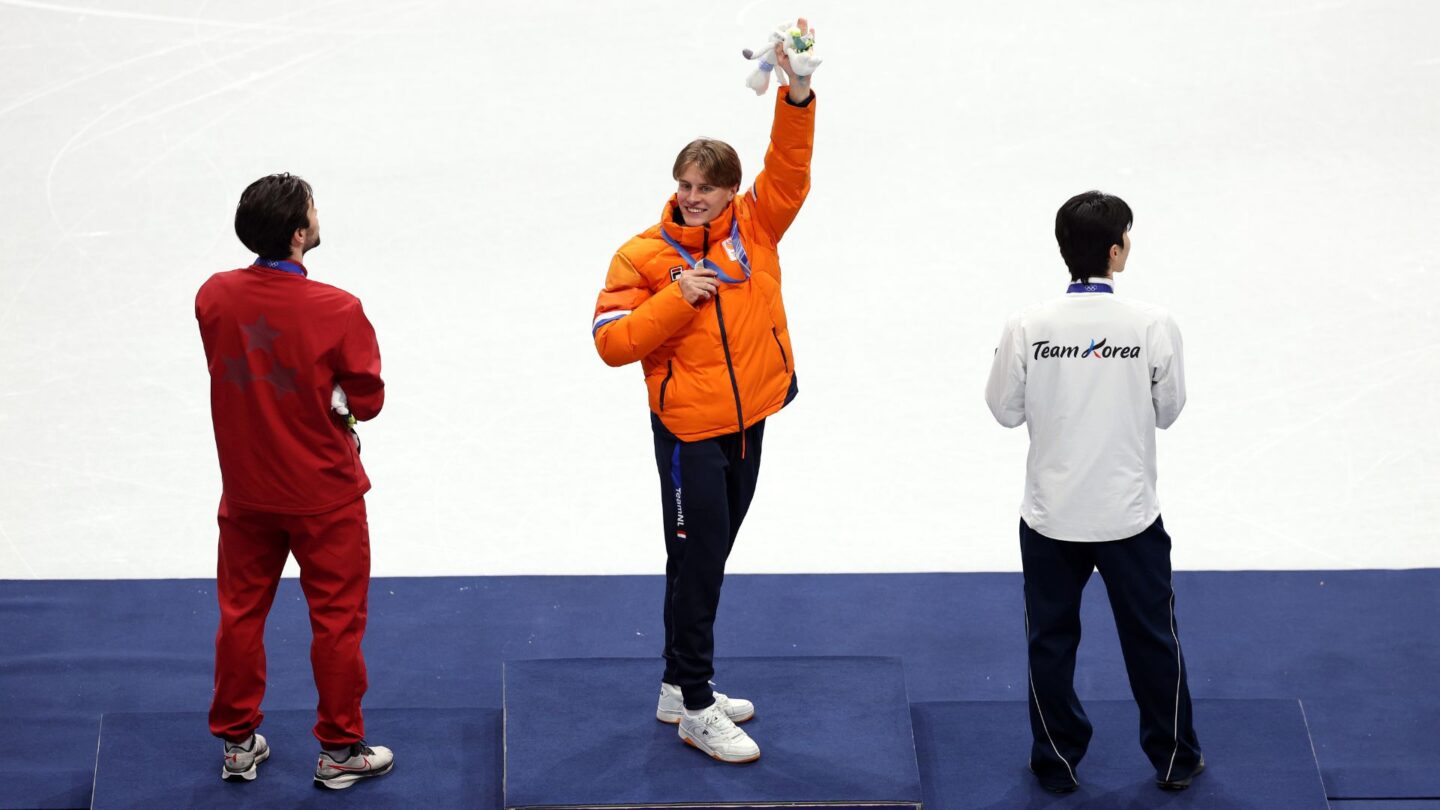 Jens van 't Wout waves from the top of the podium