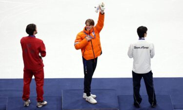 Jens van 't Wout waves from the top of the podium
