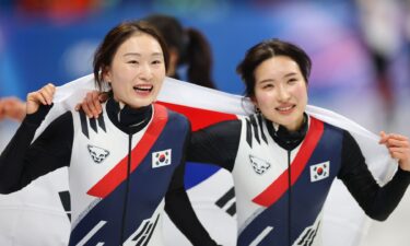 Choi Min-Jeong and Kim Gil-Li skate a victory lap with the South Korean flag