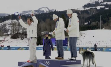 Klaebo and dog on the podium